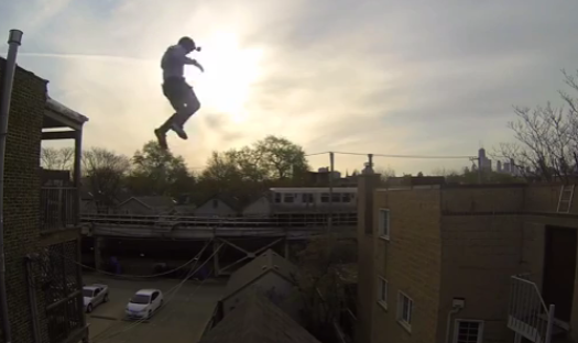 First-Person-GoPro-Video-of-a-Stuntman-Jumping-Onto-and-Sliding-Down-a-Steep-Gable-Roof-in-Chicago.png