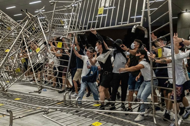 Demonstrators push metal barriers during a protest against a government proposal that could allow extraditions to mainland China, in Hong Kong.