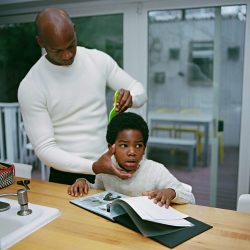 Dennis combing Élan’s hair. Brooklyn, New York © Bart Heynen from 'Dads' published by powerHouse Books