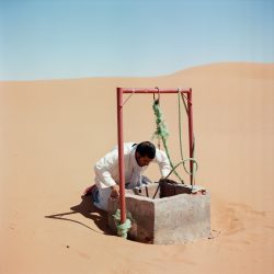 A man looking for water in the desert