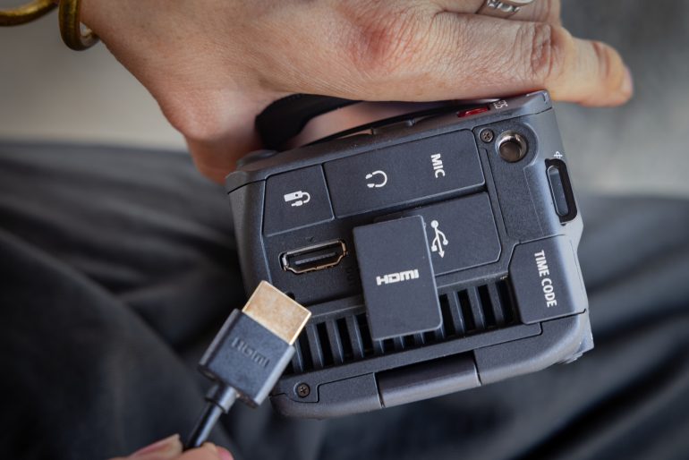 D227 lifestyle hands plugging in an HDMI cable