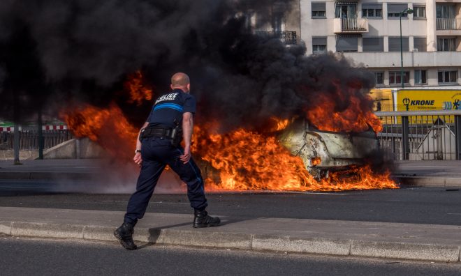 Fired up policeman trying to blow out a fire